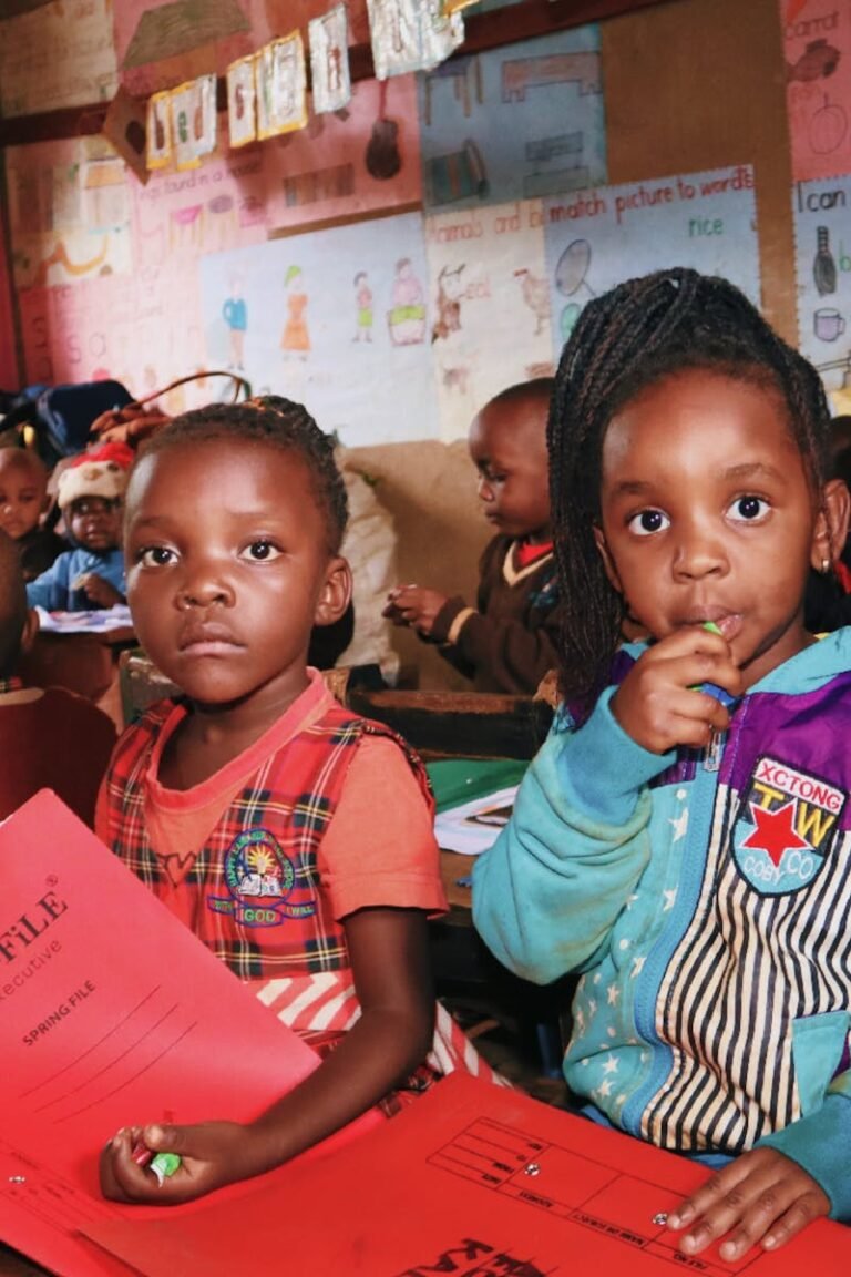 A group of young children engaged in an educational activity in a colorful classroom.