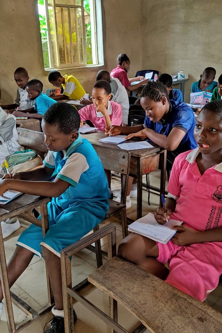 Children studying attentively in a classroom in Igbo-Etche, Nigeria, showcasing active learning.